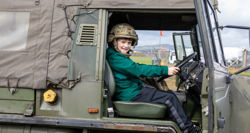 Photo caption: Young Rory Pearson is pictured at Ards Airfield in a military vehicle ahead of Armed Forces Day.